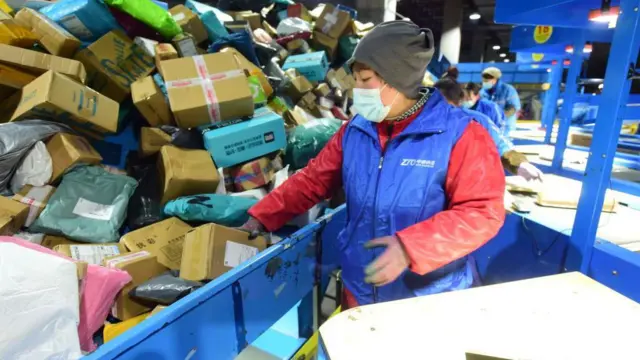 Express workers are sorting parcels on an assembly line at an e-commerce logistics industrial park in Lianyungang, Jiangsu Province, China, on February 16, 2024.
