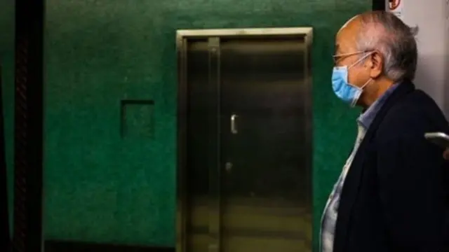 ਕੋਰੋਨਾ ਵਾਇਰਸ,ਮਾਸਕ ਨਾਲ ਮੂੰਹ ਢਕੀ ਖੜ੍ਹਾ ਇੱਕ ਬਜ਼ੁਰਗ