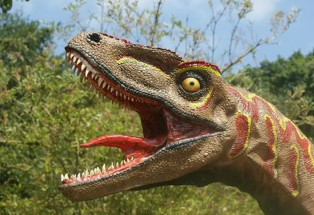 a sculpture of a dinosaur with its tongue waving wildly, a feature that is incorrect