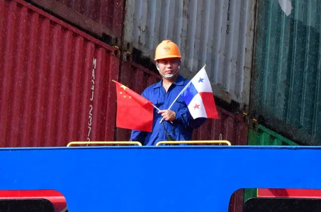 Crew members of Chinese Cosco Shipping Rose container ship stand on deck, upon arrival at the newly inaugurated Cocoli locks during the visit of China"s President Xi Jinping, in the Panama Canal, on December 3, 2018, - Chinese President Xi Jinping is on an official visit to Panama after attending the G20 Summit in Argentina. (Photo by Luis Acosta / AFP)LUIS ACOSTA/AFP/Getty Images