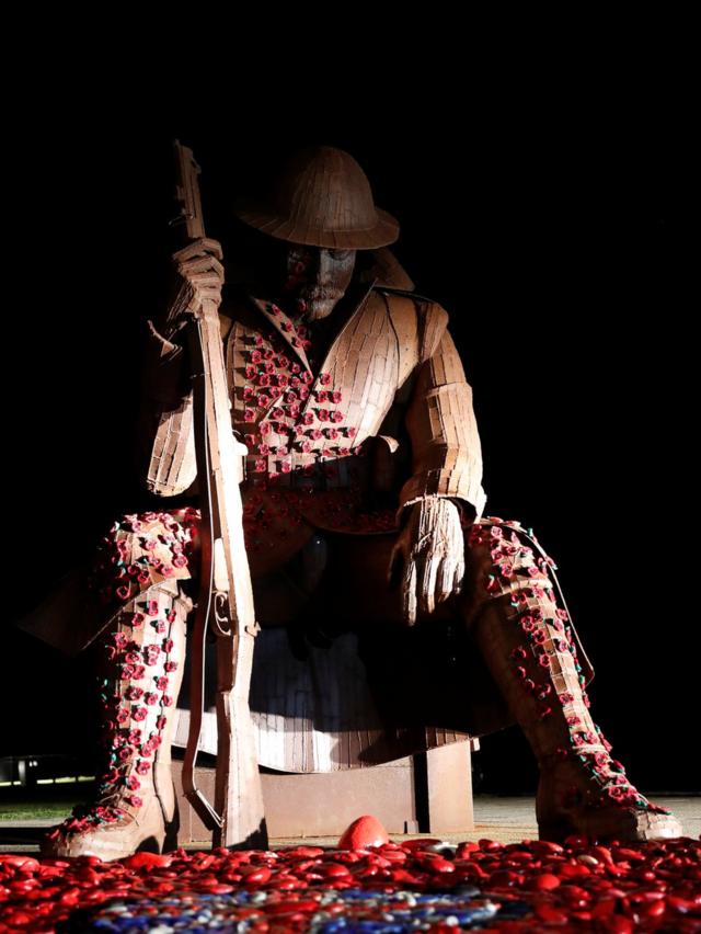 The historical statue of soldier "Tommy" on Seaham seafront in County Durham is decorated with magnetic poppies