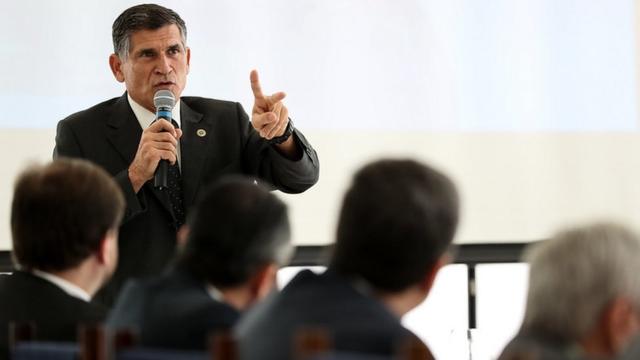 Santos Cruz fala ao microfone dianteaposta para jogo do brasilplateia