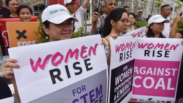 Lidy holding a banner