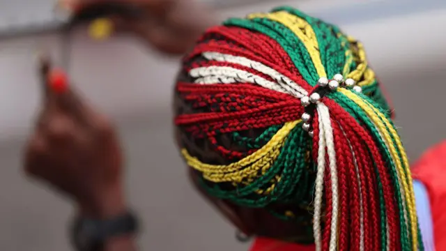 Akoko Komlanvi ta yi kitso da izgar doki launin tutar kasarta wears matching braids and nails in green s she builds her boat ahead of a rowing event at Vaires-Sur-Marne Nautical 24 Yuli 2024 a Faransa