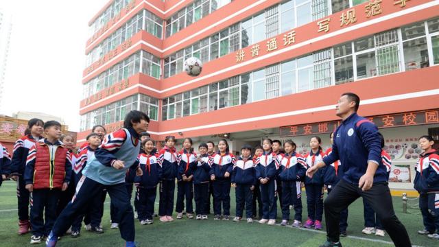 Pupils take part in a football obstacle course in Handan, North China's Hebei Province, Dec. 8, 2020. December 9th is World Football Day.