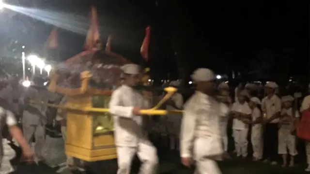 Hombres llevan una silla de manos en una boda fantasma.