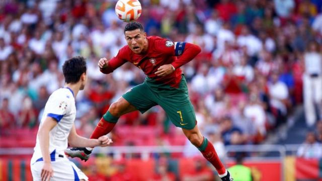 Cristiano Ronaldo heads the ball for Portugal