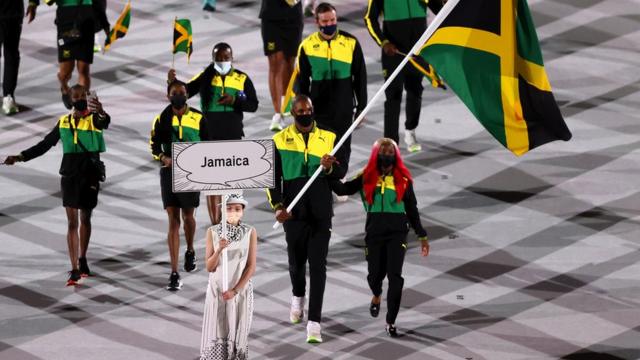 Flag bearers Shelly-Ann Fraser-Pryce and Ricardo Brown of Team Jamaica leads their team in during the Opening Ceremony of the Tokyo 2020 Olympic Games at Olympic Stadium on July 23, 2021 in Tokyo, Japan.