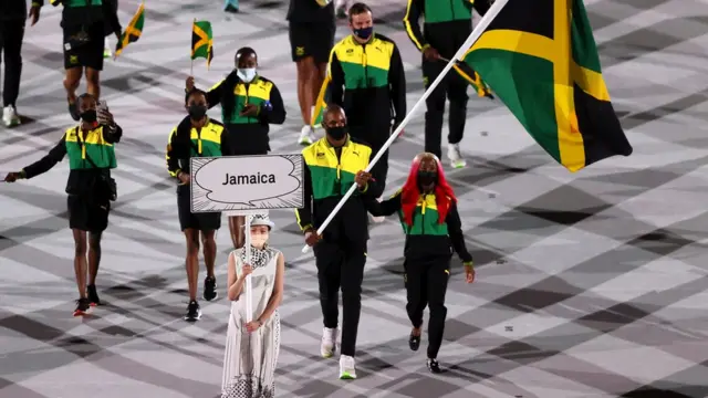 Flag bearers Shelly-Ann Fraser-Pryce and Ricardo Brown of Team Jamaica leads their team in during the Opening Ceremony of the Tokyo 2020 Olympic Games at Olympic Stadium on July 23, 2021 in Tokyo, Japan.