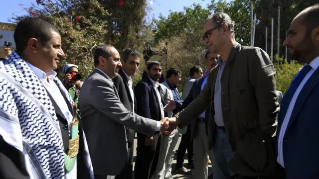 Retired Dutch general Patrick Cammaert (2nd-R), who heads a United Nations team tasked with monitoring a ceasefire between the Iranian-aligned Houthi group and Saudi-backed government forces in Yemen's Hodeidah, greets officials upon his arrival in the Yemeni capital Sanaa on December 23, 2018.