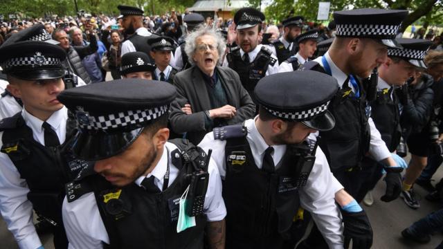 Piers Corbyn being led away by police