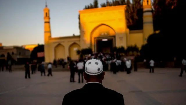 Back of one man in front of masjid