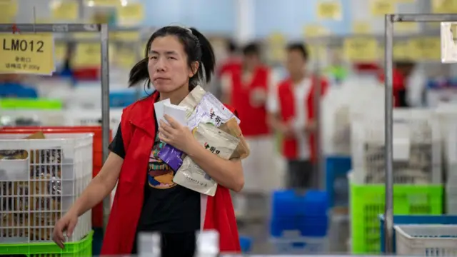 Employees pack items into boxes at a warehouse of a food factory ahead of China's Double 11 Shopping Festival on November 1, 2023 in Jinhua, Zhejiang Province of China. (Photo by VCG/VCG via Getty Images)