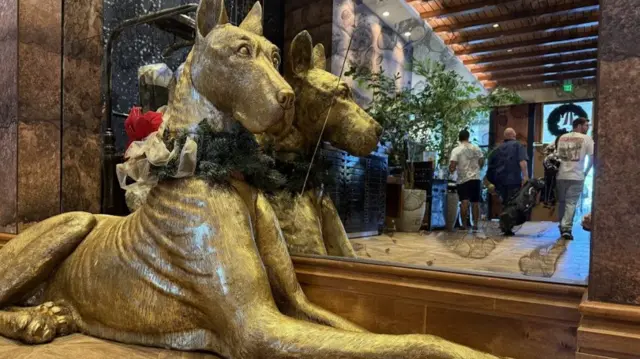 A massive golden Great Dane sculpture is seen in the lobby of The Ben hotel