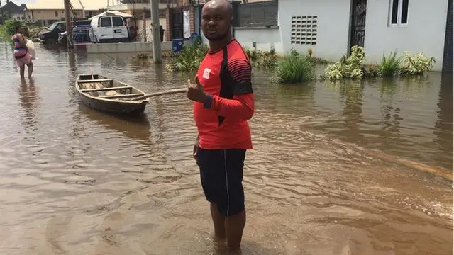 BBC reporter Andrew Gift inside flood