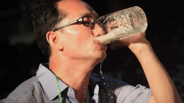 A North Korean man gulps down a glass of draft beer during a beer drinking competition held on Friday, Aug. 12, 2016 in Pyongyang, North Korea. This competition was held during a beer festival along the Taedong River in the North Korean capital.