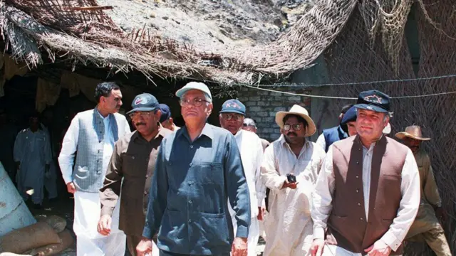 Prime Minister of Pakistan Nawaz Sharif (R) comes out of a tunnel, digged for the nuclear tests, at the site of nuclear explosions along with scientists in Chaghi district of southwestern Baluchistan province, 19 June.