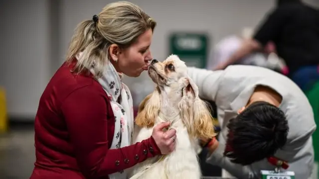 A woman kisses an American Cocker Spaniel on day 2 of the Cruft"s dog show at the NEC Arena on March 6, 2020 in Birmingham, England