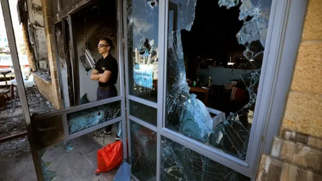 A picture taken in Acre, a mixed Arab-Jewish town in northwest Israel, on May 13,2021, shows the Uri Buri restaurant after it was attacked and heavily damaged.