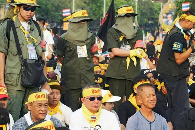 BANGKOK, THAILAND - 2006/03/14: Leaders of the People's Alliance for Democracy (PAD), Pipop Thongchai (left), Sondhi Limthongkul (centre) and Chamlong Srimuang (Right) sit side by side at the head of an anti government demonstration in the Thai capital, Bangkok. Over 100,000 people turned out to protest against the government of caretaker Prime Minister, Thaksin Shinawatra. Following widespread protests Mr. Thaksin recently dissolved parliament and called a snap election. Despite winning a landslide in the last elections, Mr. Thaksin, a telecom tycoon turned politician, has faced mounting accusations of corruption. Mr. Sondhi Limthongkul and Mr. Chamlong Srimuang along with an alliance of opposition groups are calling for Mr. Thaksin to step down.. (Photo by Yvan Cohen/LightRocket via Getty Images)