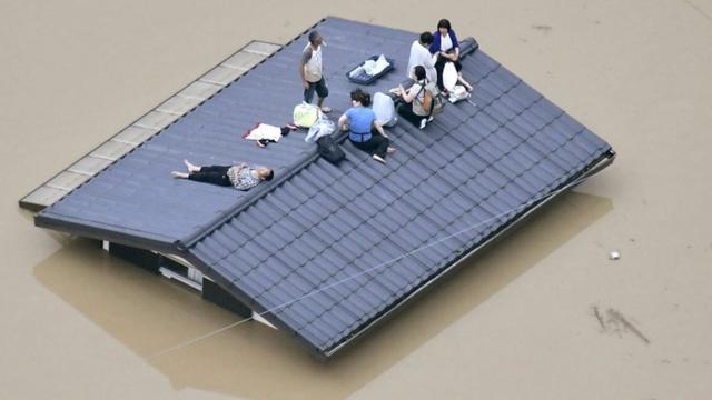People on a roof in Japan.