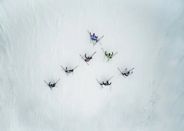 A triangle of skiers from above