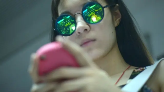 Женщина играет на телефоне