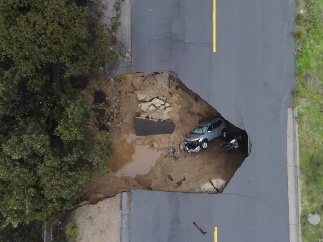 Several people had to be rescued after two vehichles fell into a sinkhole in Chatsworth, California, U.S., January 10, 2023. REUTERS/David Swanson