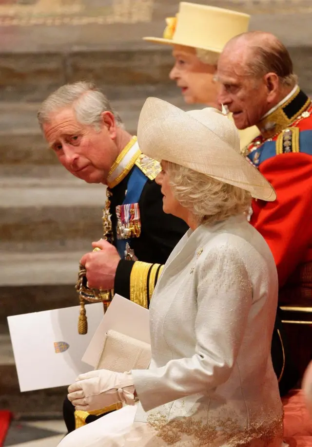Queen Elizabeth II, the Duke of Edinburgh, King Charles III and the Queen consort taking their seats at Westminster Abbey.