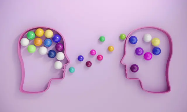 Dos siluetas con forma de cabezas y con pelotas de colores dentro