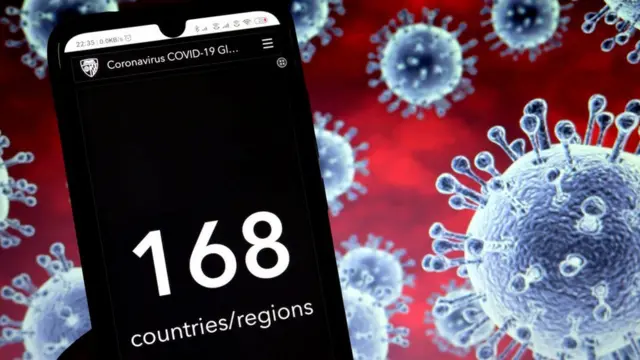 Un teléfono delante de una ilustración del coronavirus.