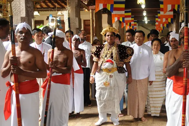 Sacred Tooth Relic Chief Custodian Pradeep Nilanga Dela (C) walks in a procession with visiting Myanmar leader Than Shwe to his left at the Buddhist Tooth Relic temple in Kandy on November 13, 2009. 