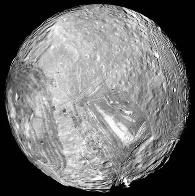 Miranda, one of the moons of Uranus, photographed by Voyager 2. The new research says the moon possibly has a sub-surface ocean and may even be home to life
