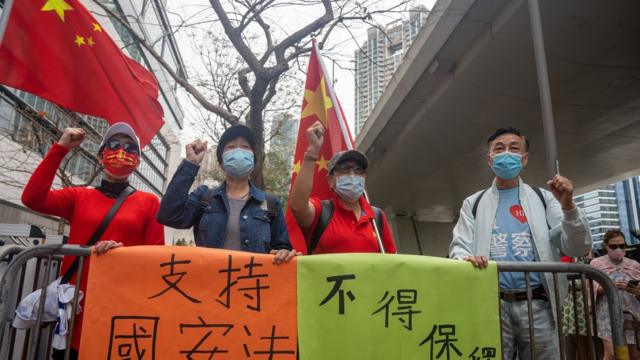 法樓大樓外同時有數人手持中國國旗，要求法官按《港區國安法》的規定不讓民主派人士保釋。
