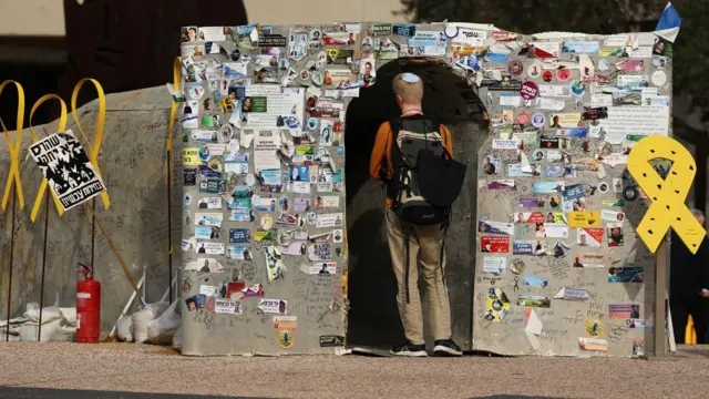 فردی وارد ماکت تونلی میشود که نماد شبکه تونلهای حماس در غزه است؛ میدان گروگانها، تلآویو (۱۴ ژانویه ۲۰۲۵)