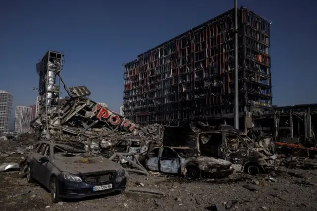 Cars are damaged at the site of a bombing at a shopping center in Kyiv as Russia"s invasion on Ukraine continues, Ukraine, March 21, 2022