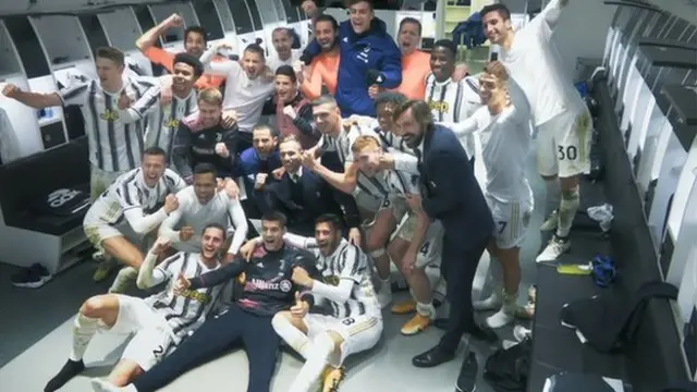 Juventus team celebrate in dressing room.