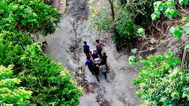 Kyar Soe, an injured rebel platoon commander, is carried to the operating table