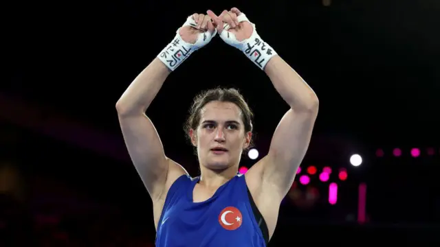 Esra Yildiz Kahraman of Team Türkiye reacts by crossing her fingers to make an X after defeat to Yu Ting Lin of Team Chinese Taipei in the Women's 57kg Semifinal match on day twelve of the Olympic Games