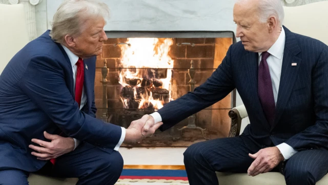 US President Joe Biden shakes hands with US President-elect Donald Trump during a meeting in the Oval Office of the White House 