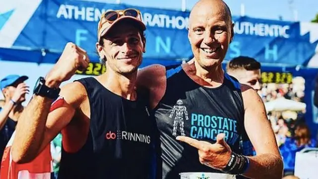 Left to right: Nick Butter and Kevin Webber, celebrating at the finish line of the Athens marathon.