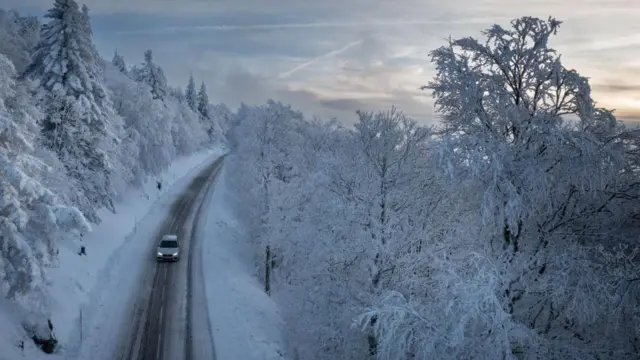 Car driving for mountai area covered wit snow