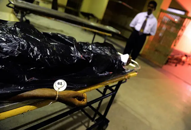 SRILANKA-PRISON-RIOT A Sri Lankan hospital worker stands next to a stretcher with a body of a victim of clashes between elite police Special Task Force and inmates, at the main hospital, in Colombo on November 10, 2012.