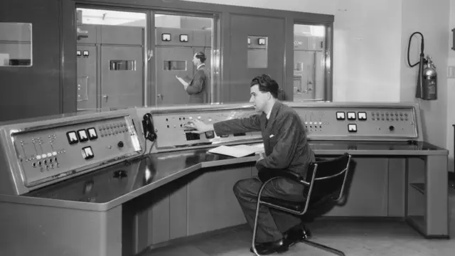  Two men at work in the control room at the BBC transmitter in Daventry