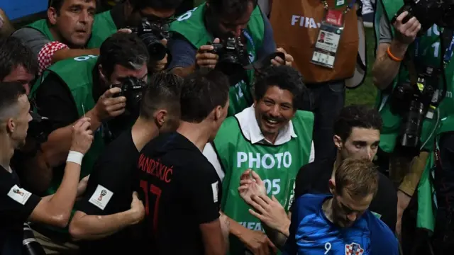 Photographers crowd around the Croatian players