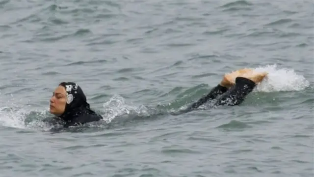ফ্রান্সের দক্ষিণে একজন মুসলিম নারী বুরকিনি পড়ে সাঁতার কাটছেন।
