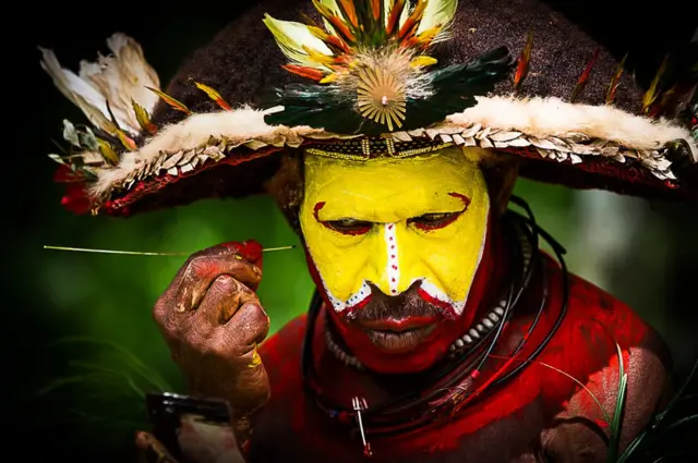 A man applies make-up