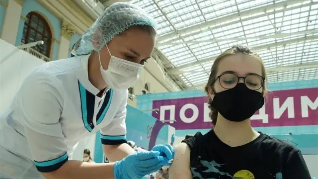 A woman receives a dose of Sputnik V (Gam-COVID-Vac) vaccine against the coronavirus disease (COVID-19) at a vaccination centre in Gostiny Dvor in Moscow, Russia July 6, 2021