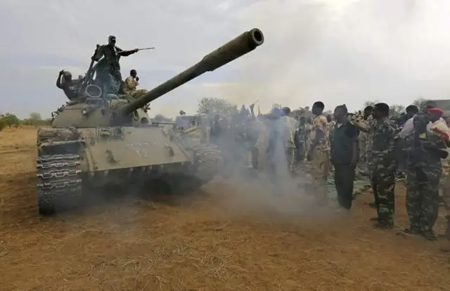 Sudan government troops with a tank