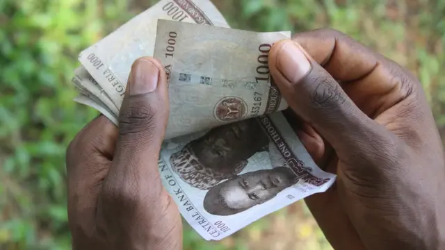 Holding naira notes
